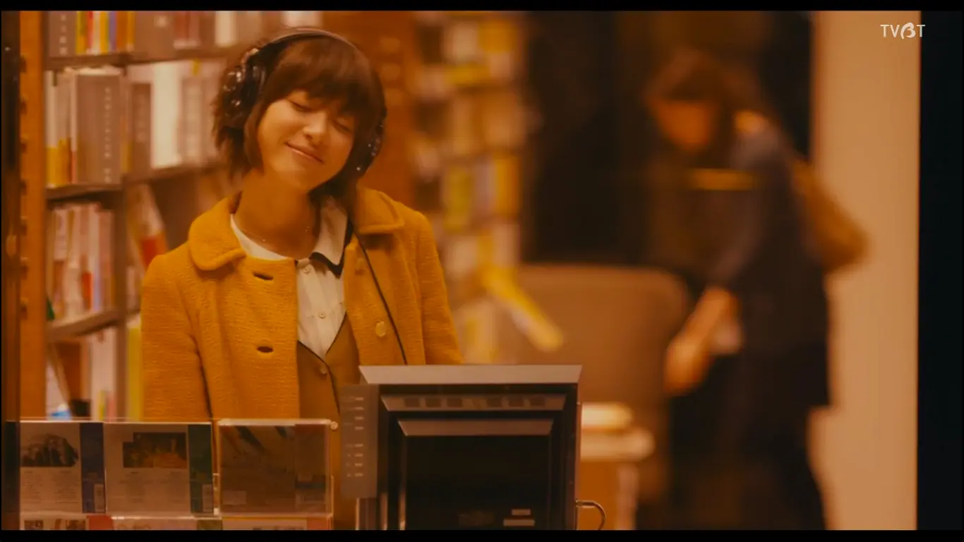 レコード店でヘッドホンをつけて音楽を聴く真緒